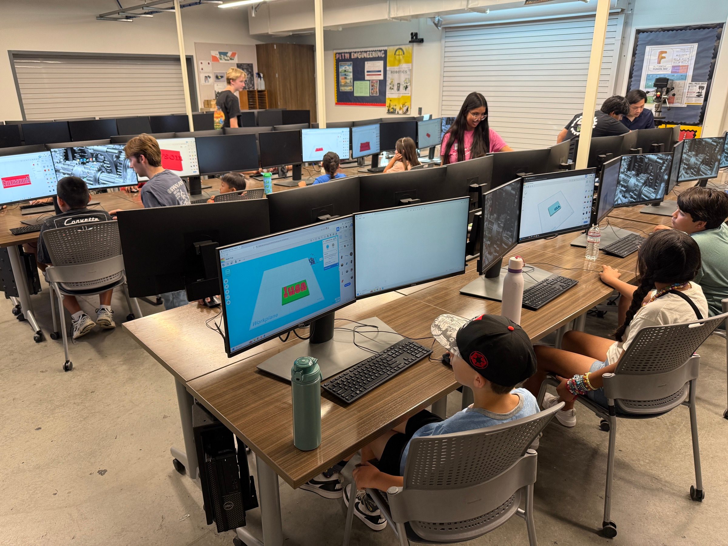 Students designing personalized keychains on classroom computers