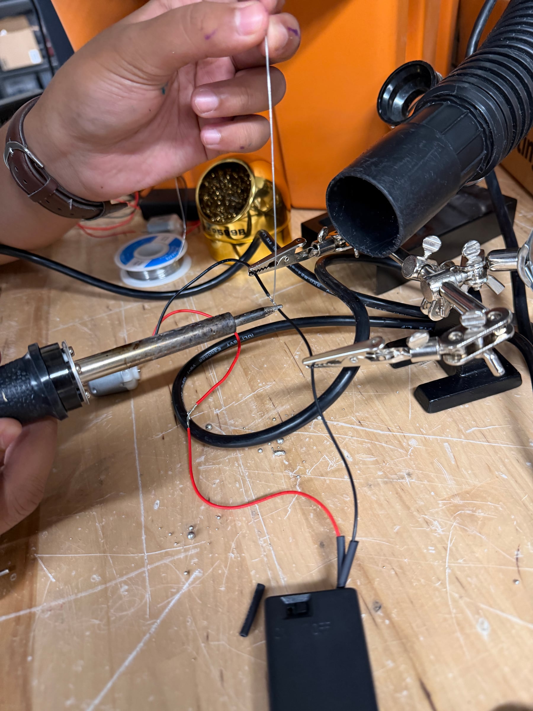 Instructor soldering a motor to a switched battery holder